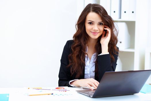 Young pretty business woman with notebook in the office