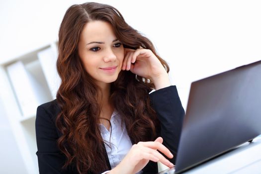 Young pretty business woman with notebook in the office