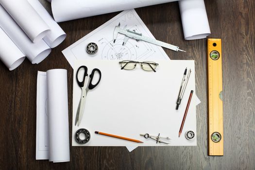 Tools and papers with sketches on the table