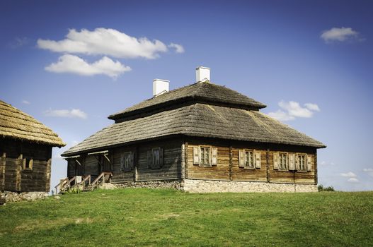 Beautiful landscape with restored old style russian farmhouse with thatch roof 