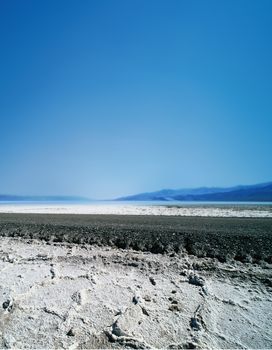 vast arid region with asphalt road and saline