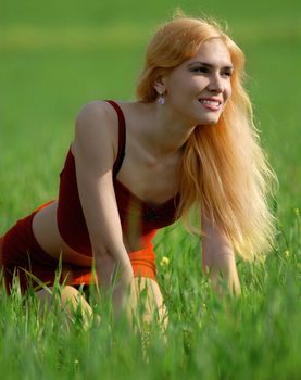 beautiful blond woman on the green field