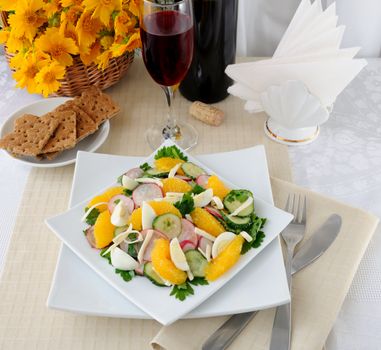 Salad of radish and cucumber with egg, cheese and orange