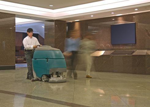 Cleaning floor in office building lobby