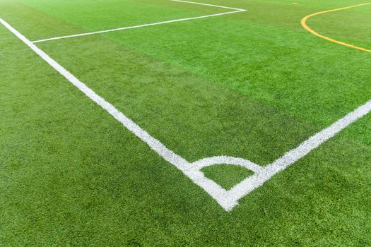 Artificial turf football field with white line corner