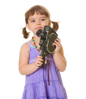 A curious child with an old movie camera in his hands isolated on white background