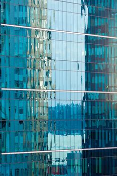 Background of beautiful blue reflections with a rippled effect in a modern coporate glass-walled building facade