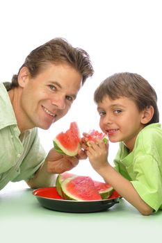 Father and son enjoy eating sliced watermelon together with white background