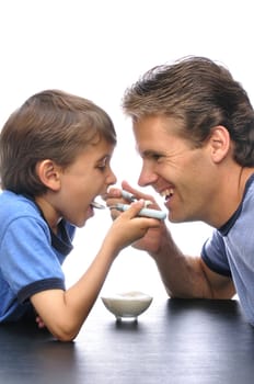 Father and son sharing a bowl of yogurt together with white background