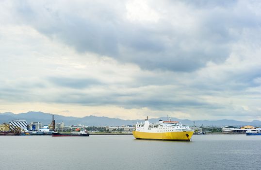 Yellow ship in industrial harbor. Cebu, Philippines