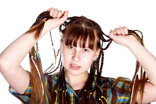 The teenage girl with plaits on a white background