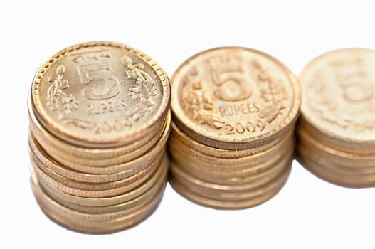 Closeup of Indian Coin stack, 5 rupees, isolated on white background, copy space,