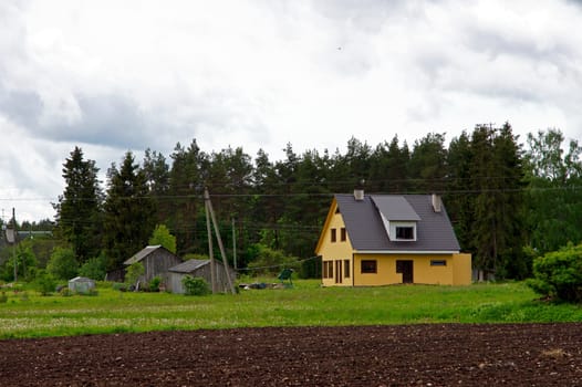 The modern house on a background of green trees