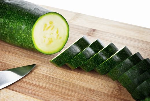 Sliced zucchini on a wooden cutting board