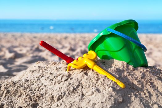 Child's toys on sandy beach, summer holidays concept