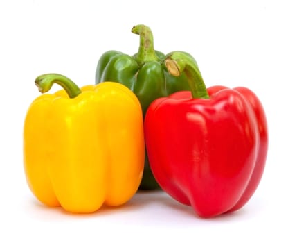 Three sweet peppers in yellow, red and green color