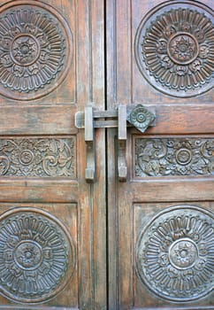 Old ancient gate. Brown antique wooden bolts.