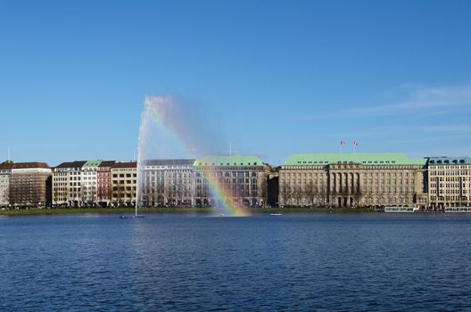 View on the Alster fountain in Hamburg. Rainbow effect.