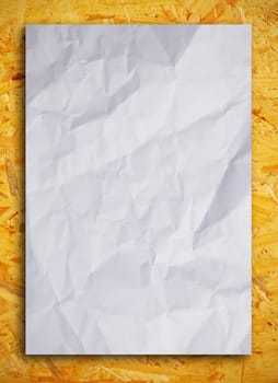 Crumpled paper on wood background