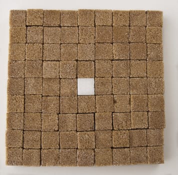 Brown sugar square in a square with one white one in the middle