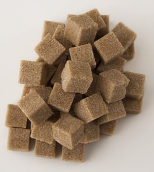 cubes of brown sugar stack in random fashion