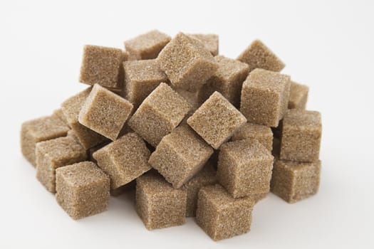 cubes of brown sugar stack in random fashion