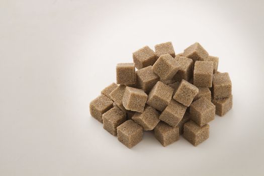 cubes of brown sugar stack in random fashion