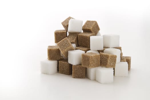 cubes of brown and white sugar stack in random fashion