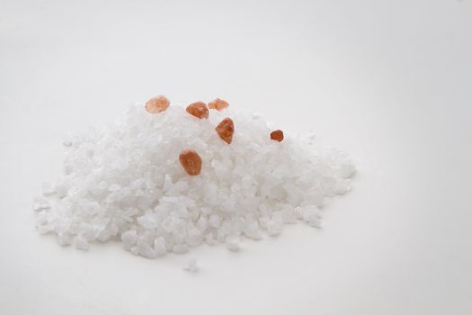 Pile of white salt crystal with 6 pink salt crystal