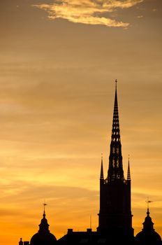 View of Stockholm old town and Riddarholmen church tower at sunset
