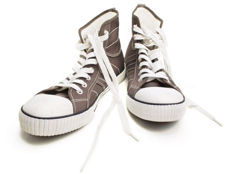 Two brown sneakers isolated on a white background. Closeup view.