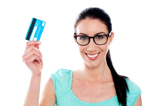 Close-up portrait of young smiling holding credit card isolated on white background