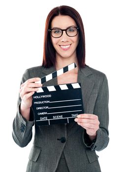 Business lady holding clapperboard. Shot on white background