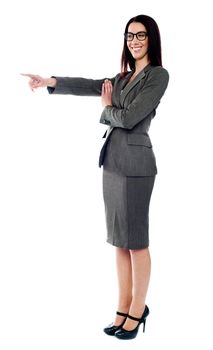 Beautiful young woman pointing to the right side. Copy space concept