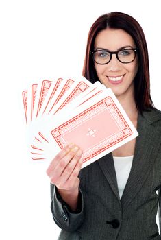 A beautiful woman holding playing cards trying her luck