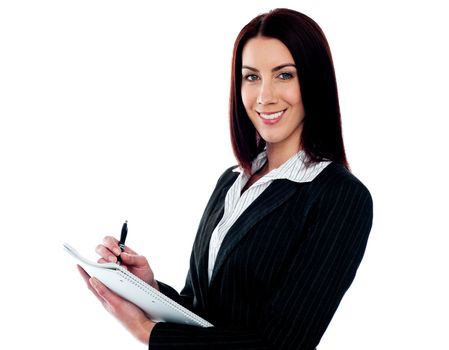 Young beautiful businesswoman writing on clipboard. Isolated against white