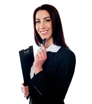Female executive holding a clipboard and pen. Smiling