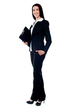 Full length of young businesswoman holding documents