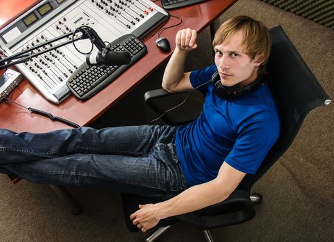 Dj working in front of a microphone on the radio, from the top