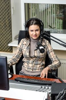 Anchorwoman in front of a microphone on the radio