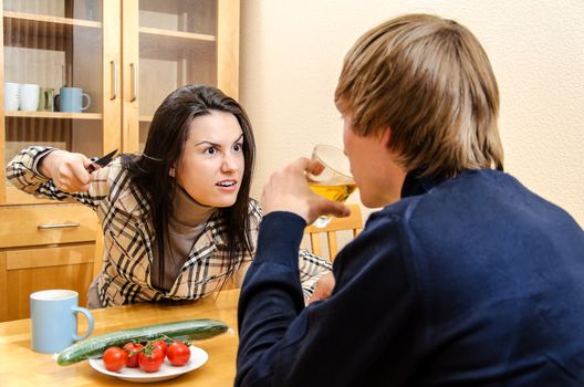 Wife quarrels with her husband in the kitchen