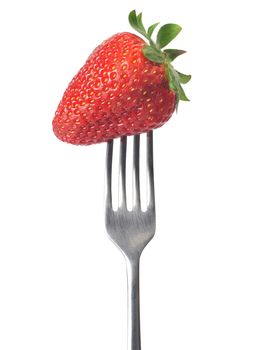 Fresh big strawberry on a fork against white background