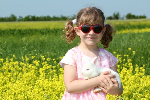 little girl holding white dwarf bunny