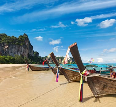Long tail boats on tropical beach in Thailand