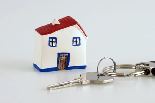 Closeup of a silver house key with a house model