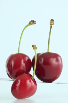 Fresh red cherries with stem on the white background