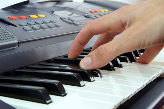 Hand of man playing the electric piano