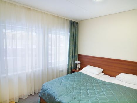 Bedroom with white pillows and sunny window