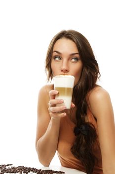 beautiful woman drinking latte macchiato coffee looking to side on white background