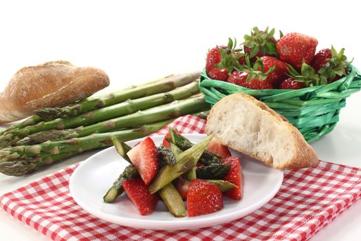 a plate of asparagus strawberry salad with roasted green asparagus